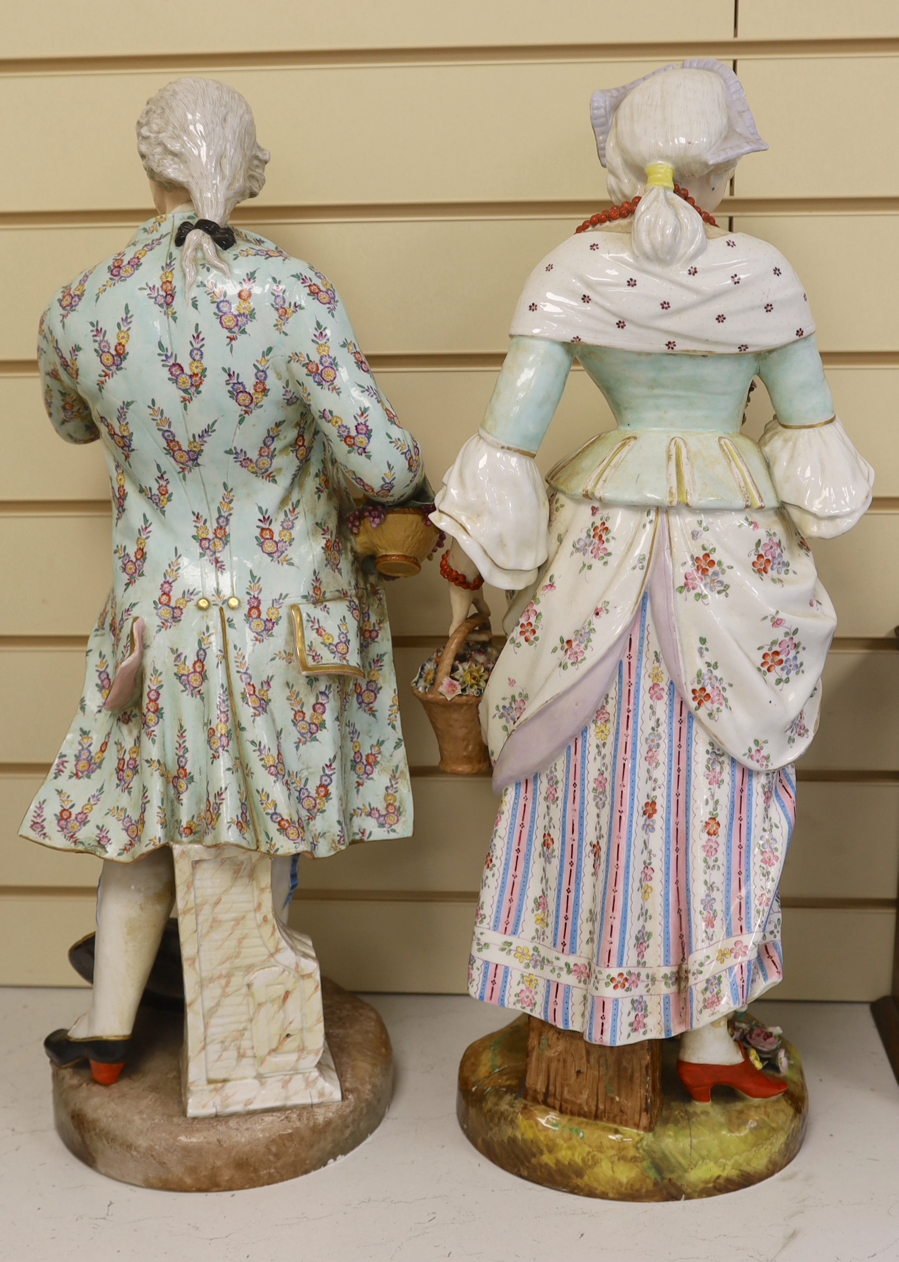 A pair of massive German porcelain figures of flower sellers, late 19th century, 66.5cm